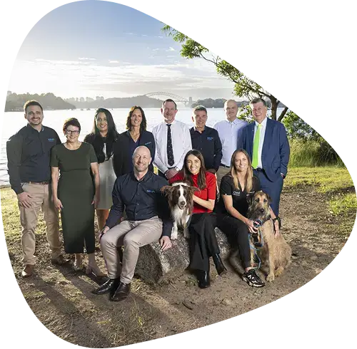 Group photo of the members in front of a scenic background
