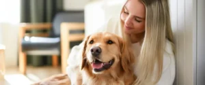 A dog sitting with its owner