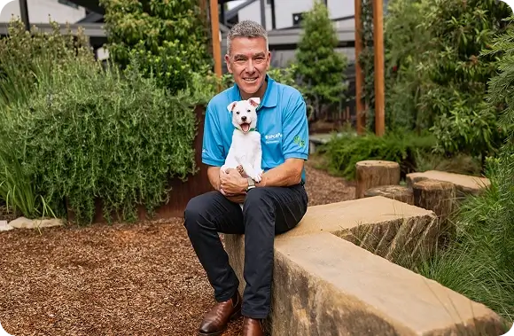 Brad Smith - CEO, RSPCA Pet Insurance sitting with a dog